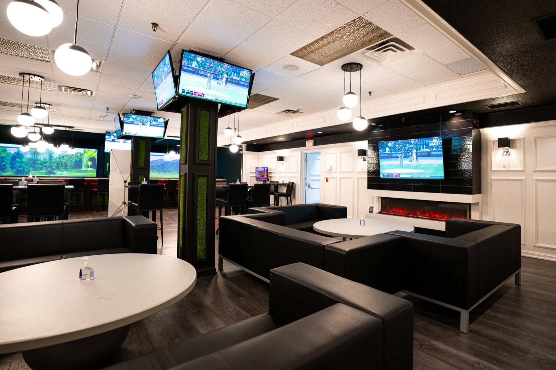 Couch clusters, screens and the fireplace across the lounge floor