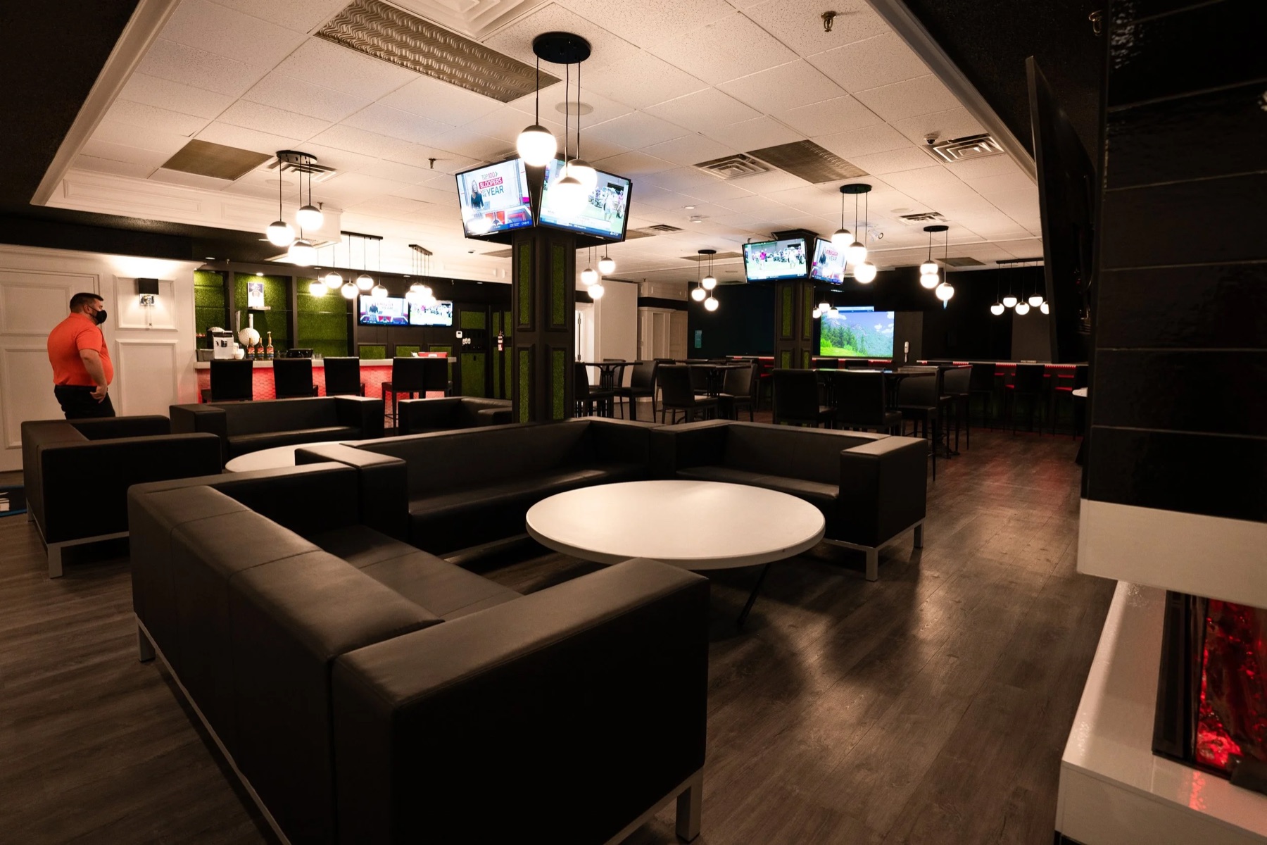 The lounge floor with couches, screens and the bar